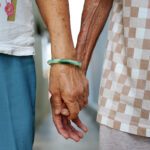 A senior couple holding hands