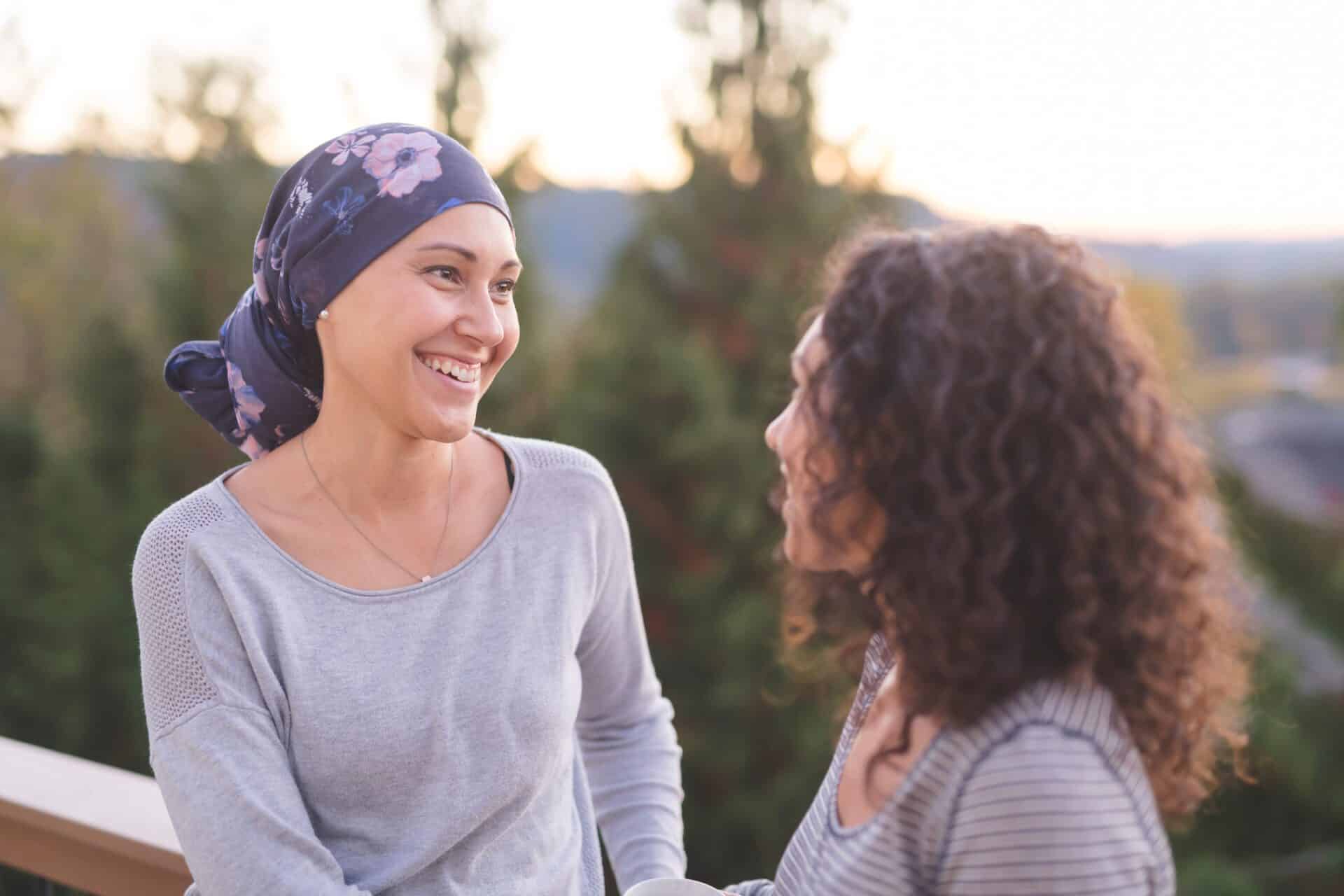 Beautiful woman battling cancer talking with her younger sister