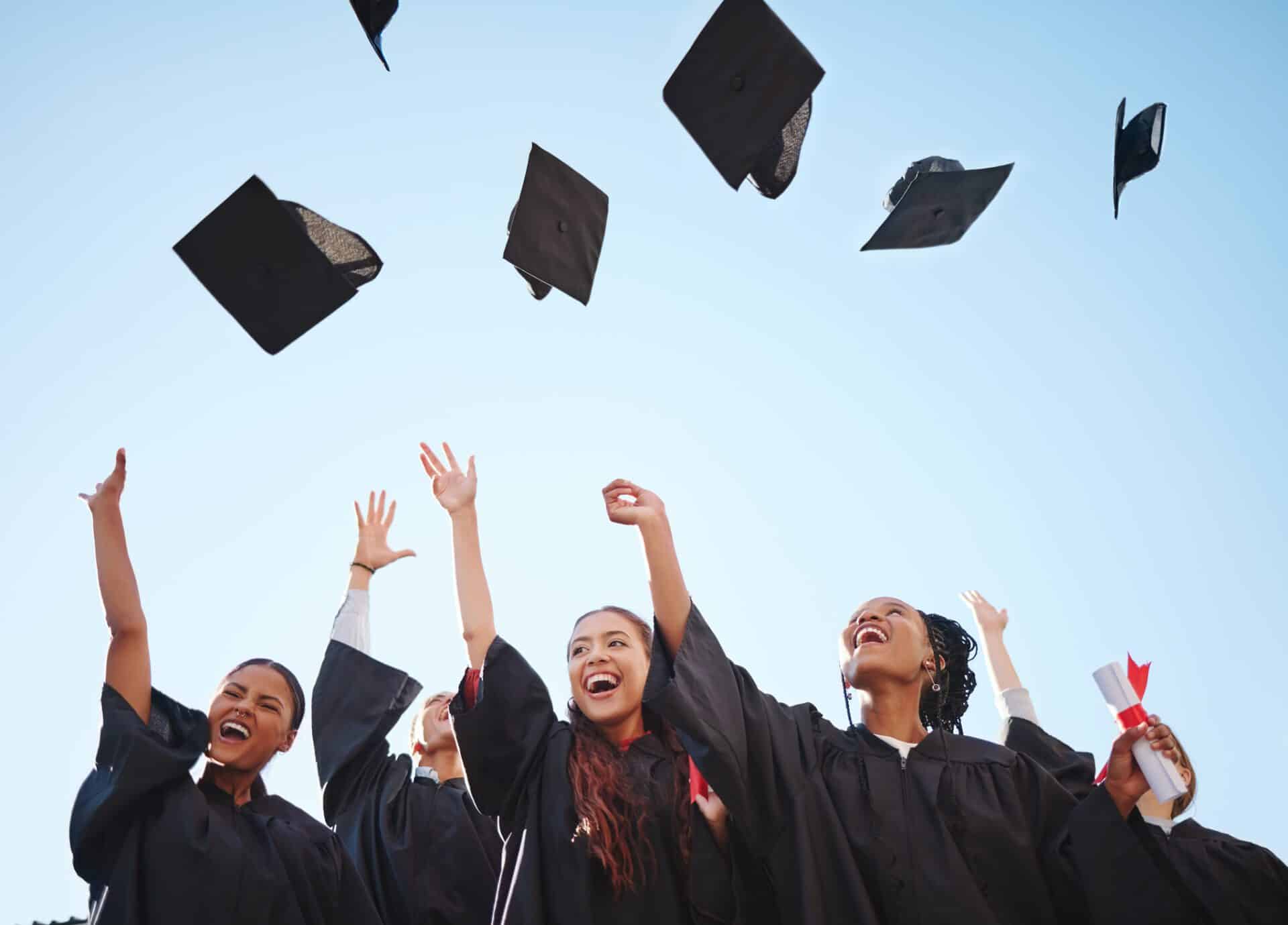 Graduation cap, student and graduate class happy at a diploma and education success ceremony. University or college students and friends with happiness smile proud of certificate achievement